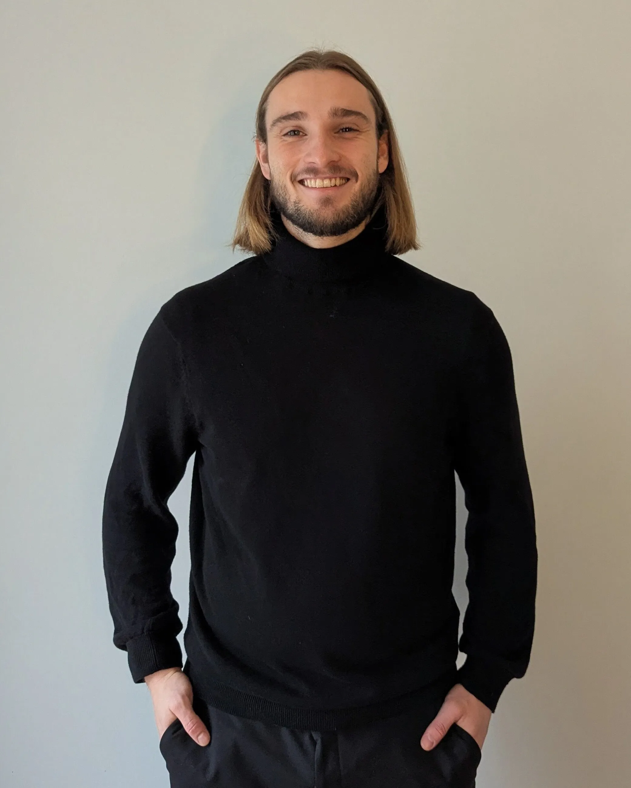 Leonard Guelmino, smiling in a black turtleneck